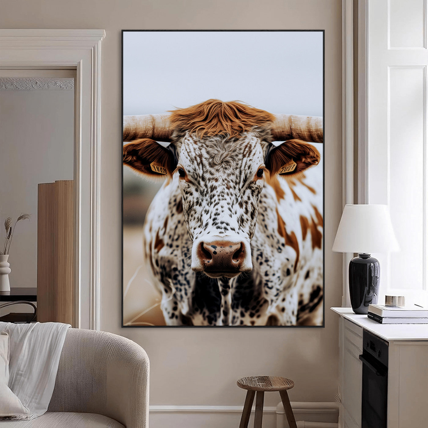 Close-up of a speckled Texas longhorn with wide horns and a bold gaze, perfect for rustic or country-style decor in warm tones.