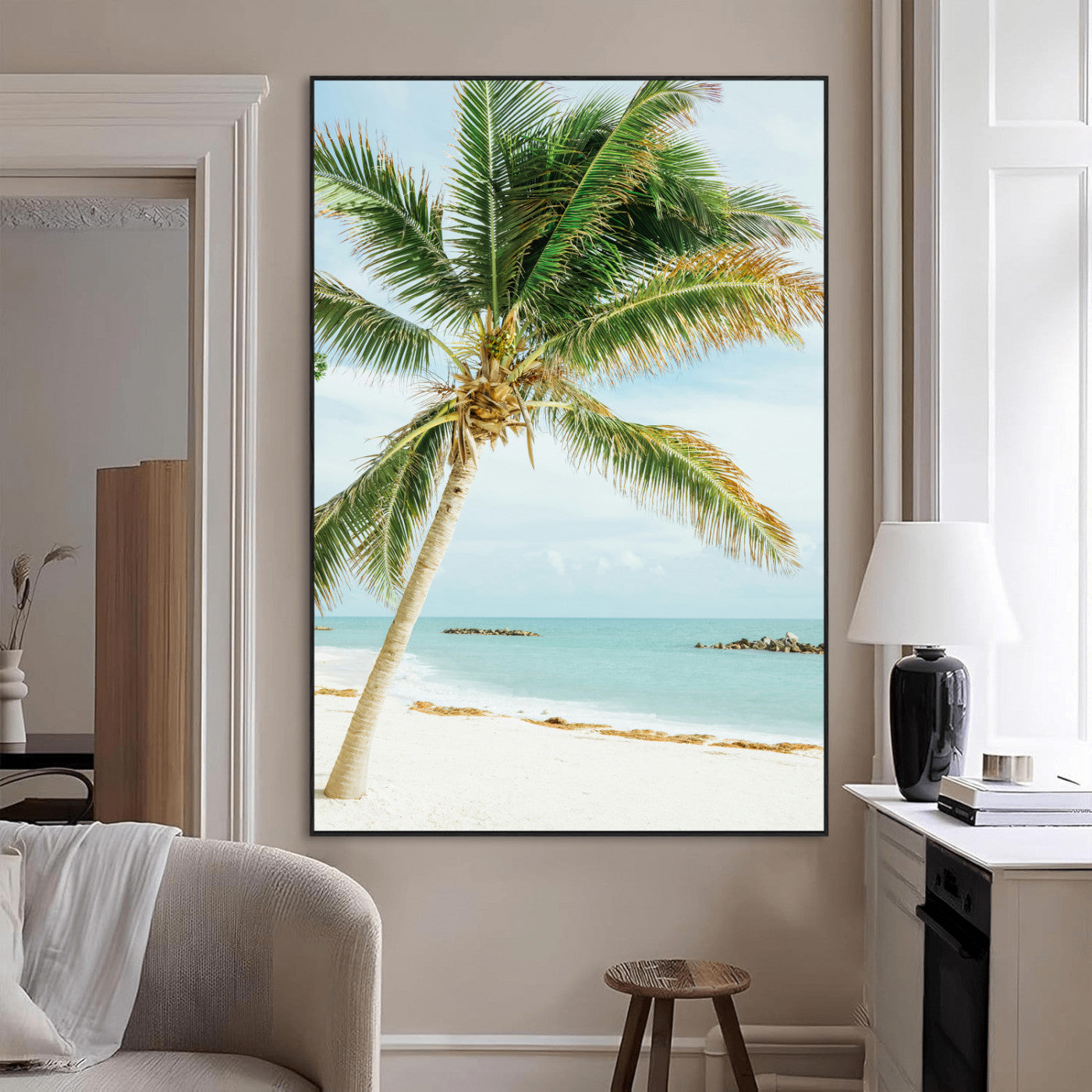 A tall palm tree leaning over a white sandy beach with turquoise ocean waves, creating a peaceful and tropical coastal scene.