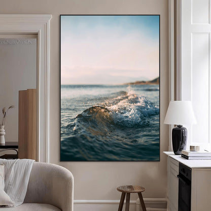 Close-up of ocean waves rolling gently toward the shore at sunset, creating a peaceful and minimalist coastal scene.