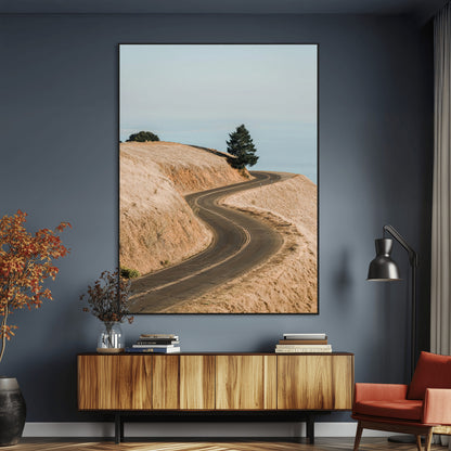 Earth-toned photograph of a winding road through golden hills, ideal for neutral or rustic-themed decor with a calming travel vibe.