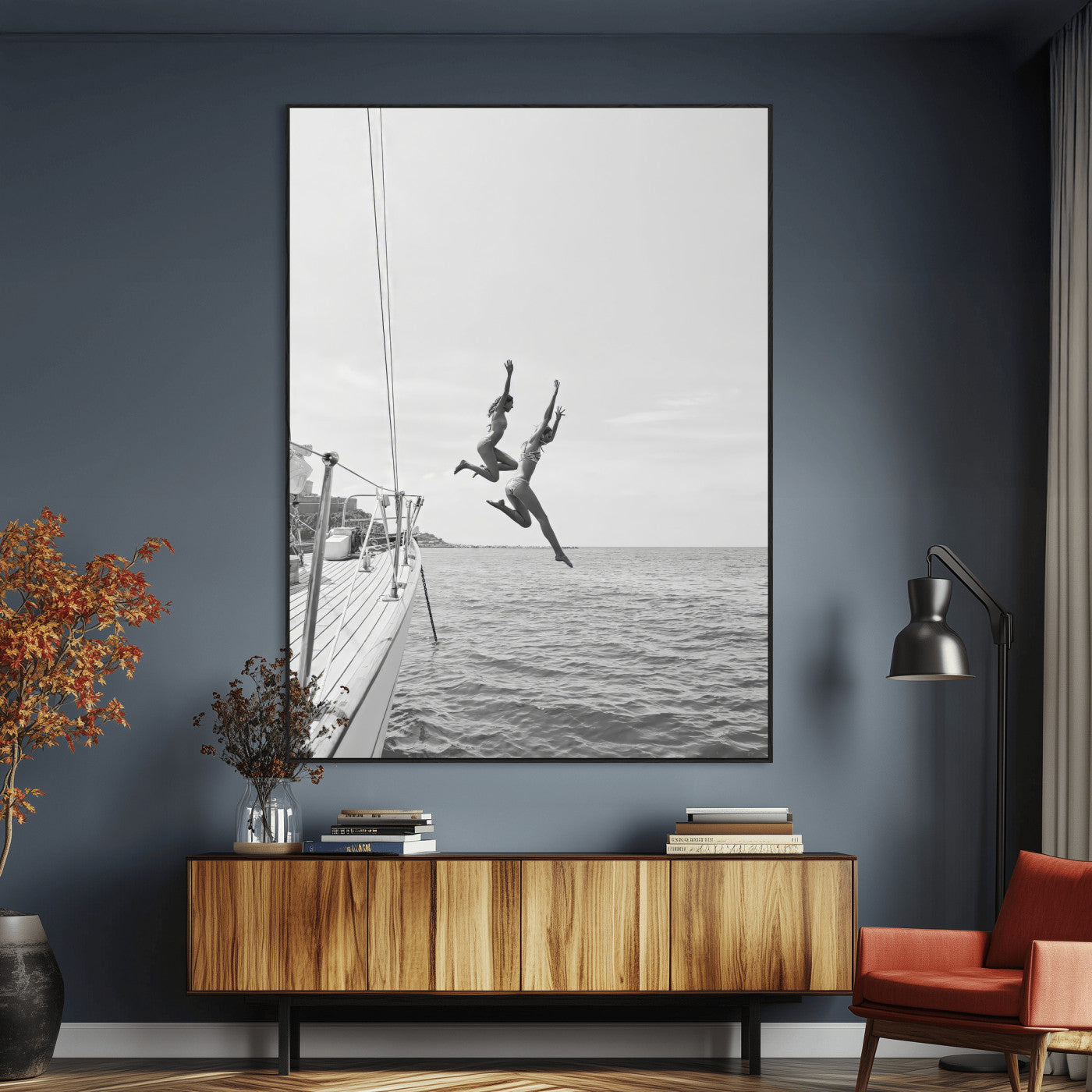 Black and white canvas wall art of two women joyfully jumping off a yacht into the sea, ideal for minimalist coastal or nautical-themed spaces.