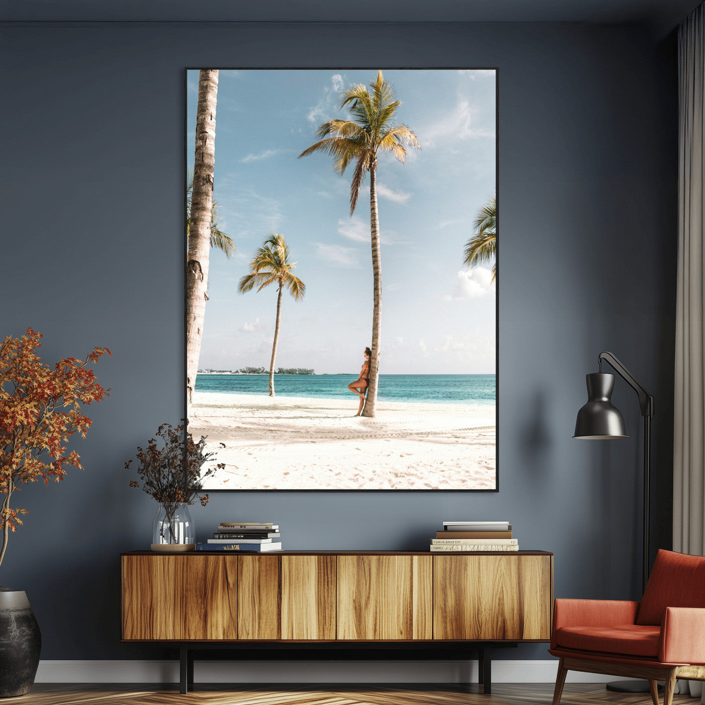 Person leaning on a palm tree at a tropical beach with white sand and turquoise water, perfect for coastal or beach-themed home decor.