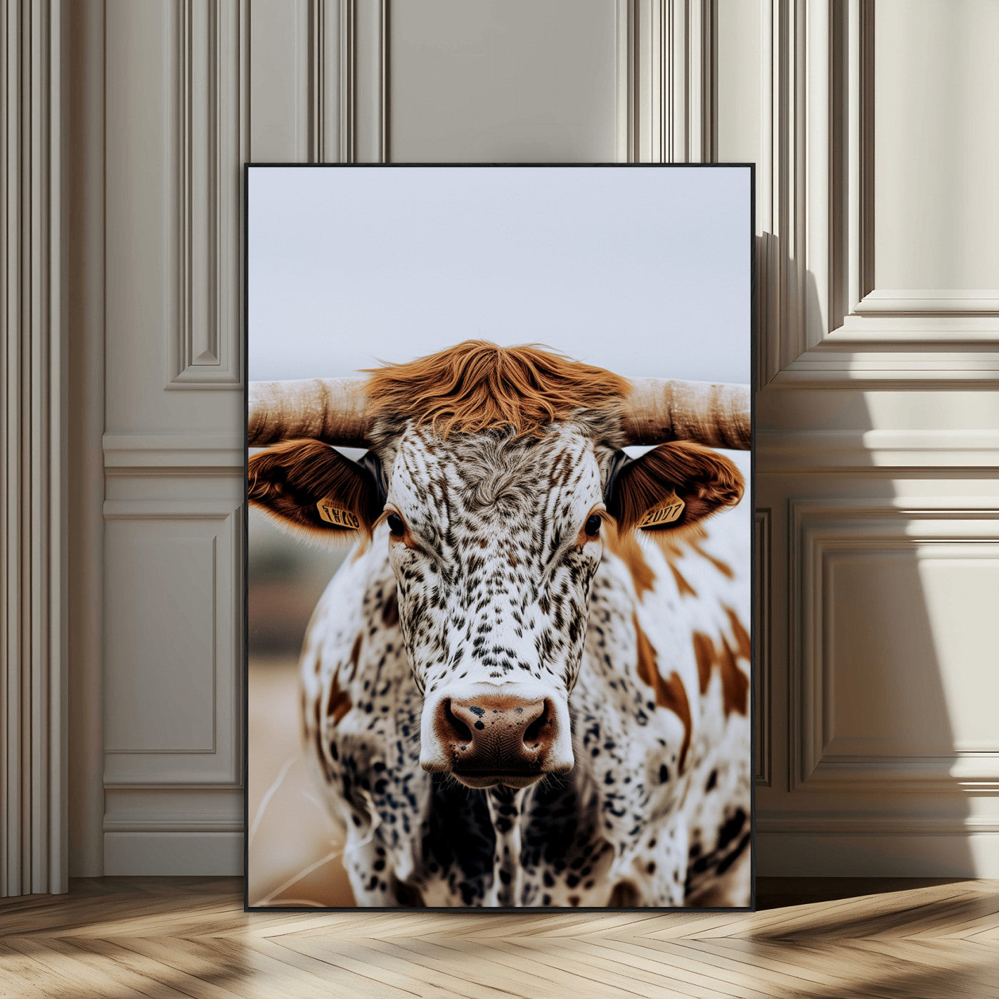 Close-up of a speckled Texas longhorn with wide horns and a bold gaze, perfect for rustic or country-style decor in warm tones.