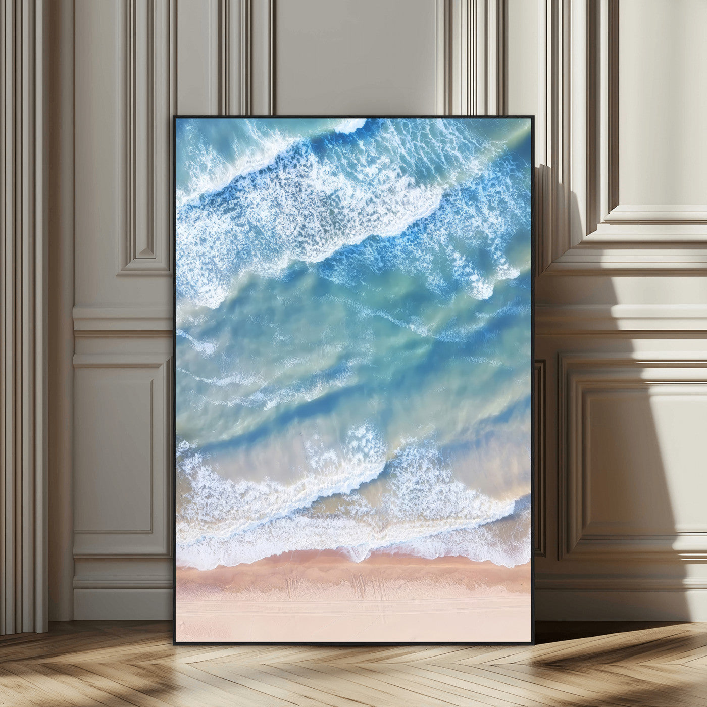 Aerial photo of soft blue waves meeting sandy shore, perfect for modern coastal or beach-themed decor with a light and tranquil aesthetic.