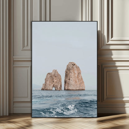 Serene photograph of the Faraglioni rocks in Capri with calm blue waters, perfect for Mediterranean coastal or minimalist travel-themed decor.