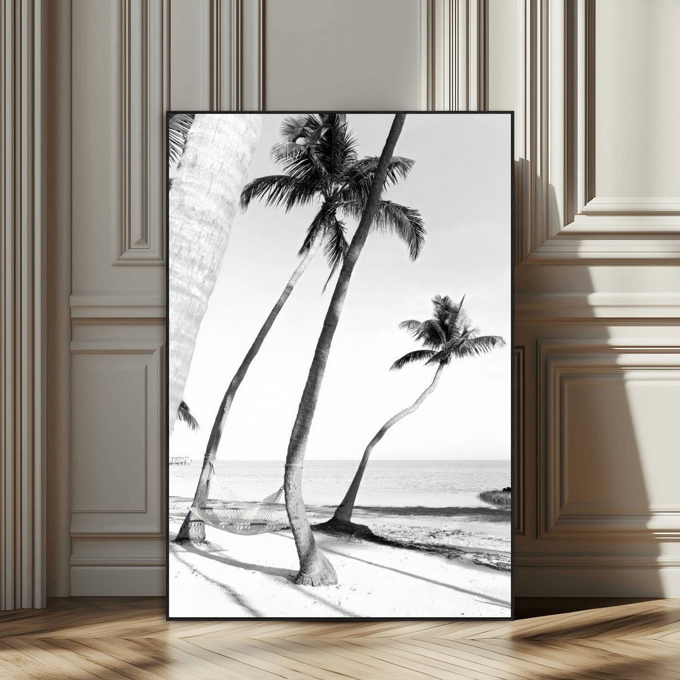 Black and white wall art of palm trees and a hammock on a beach, ideal for coastal minimalist or tropical-themed decor.