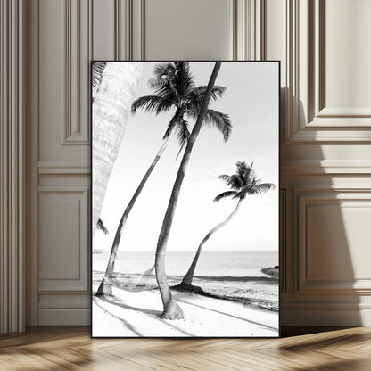 Black and white wall art of palm trees and a hammock on a beach, ideal for coastal minimalist or tropical-themed decor.