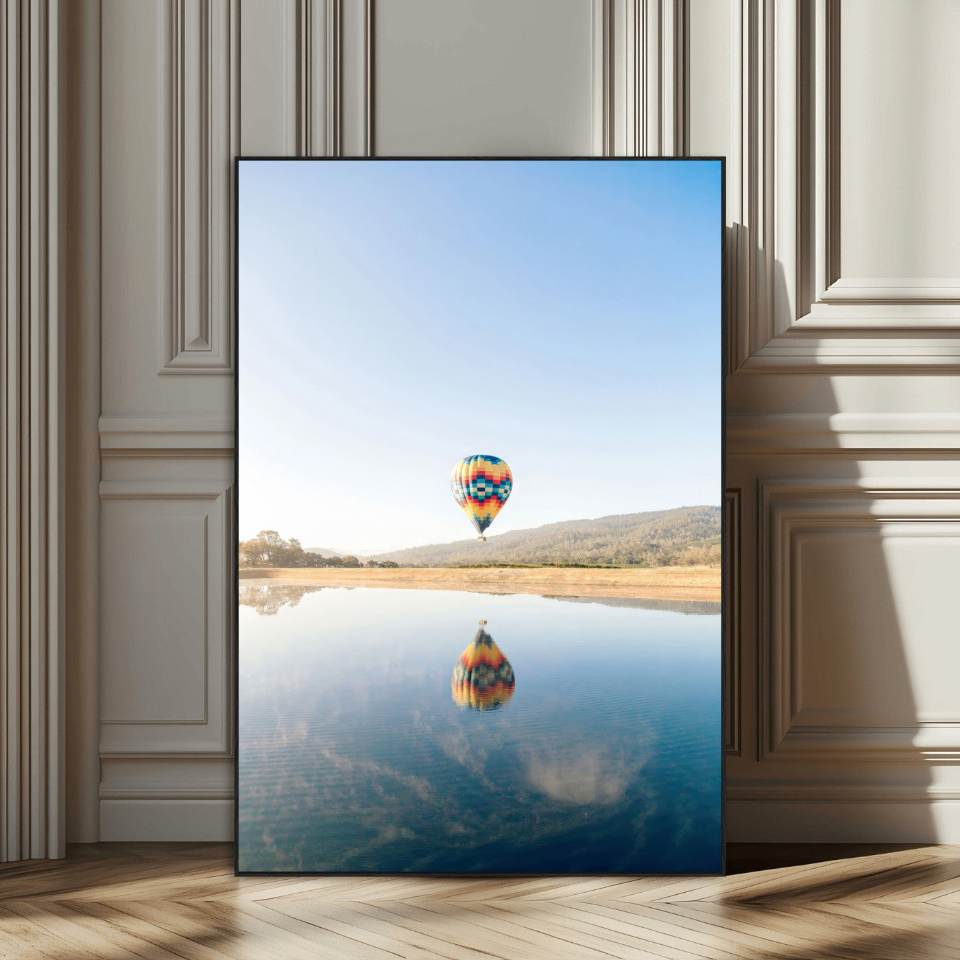 Canvas of a hot air balloon floating above a calm lake with soft reflections and vibrant sky, ideal for modern minimalist or adventure-themed home decor.