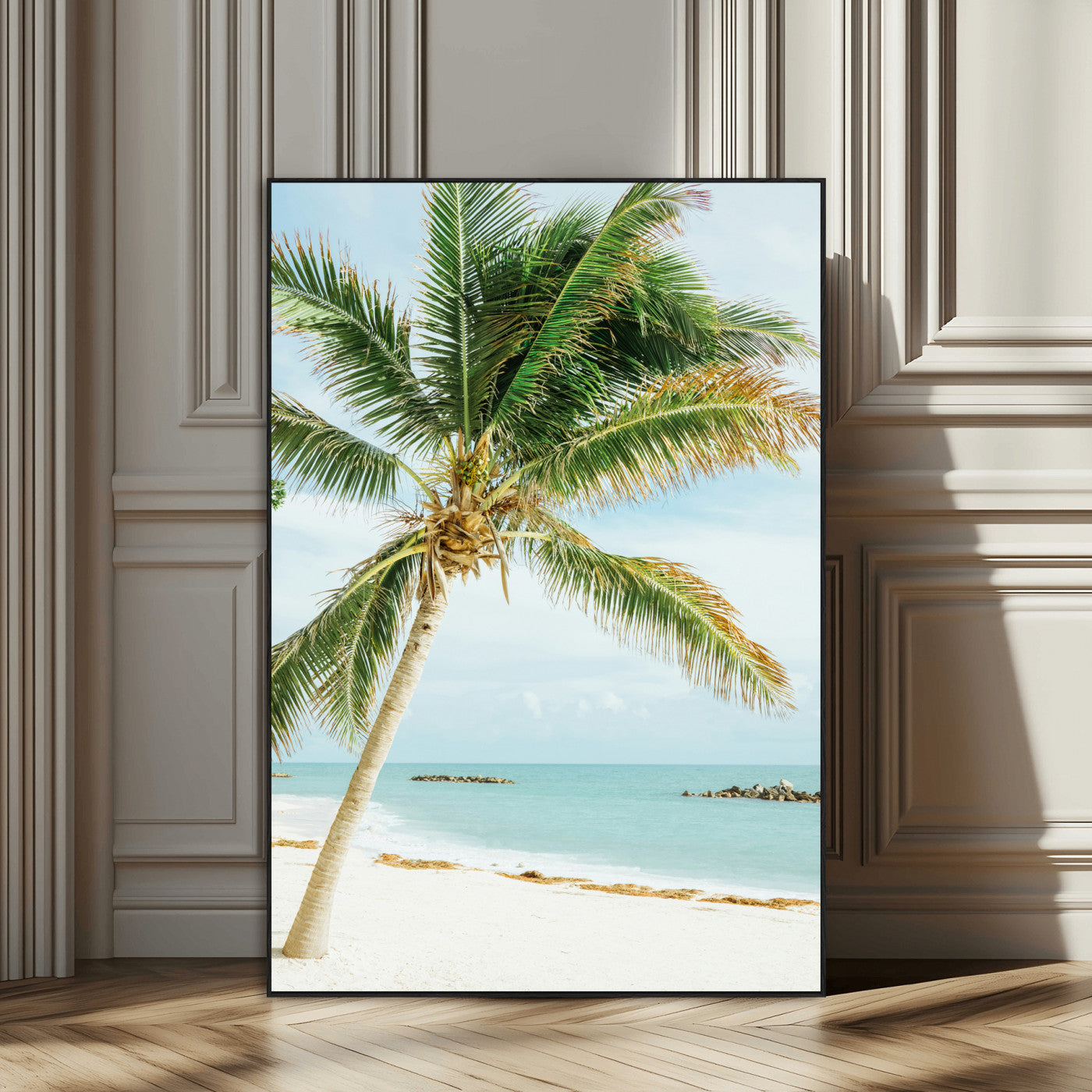 A tall palm tree leaning over a white sandy beach with turquoise ocean waves, creating a peaceful and tropical coastal scene.