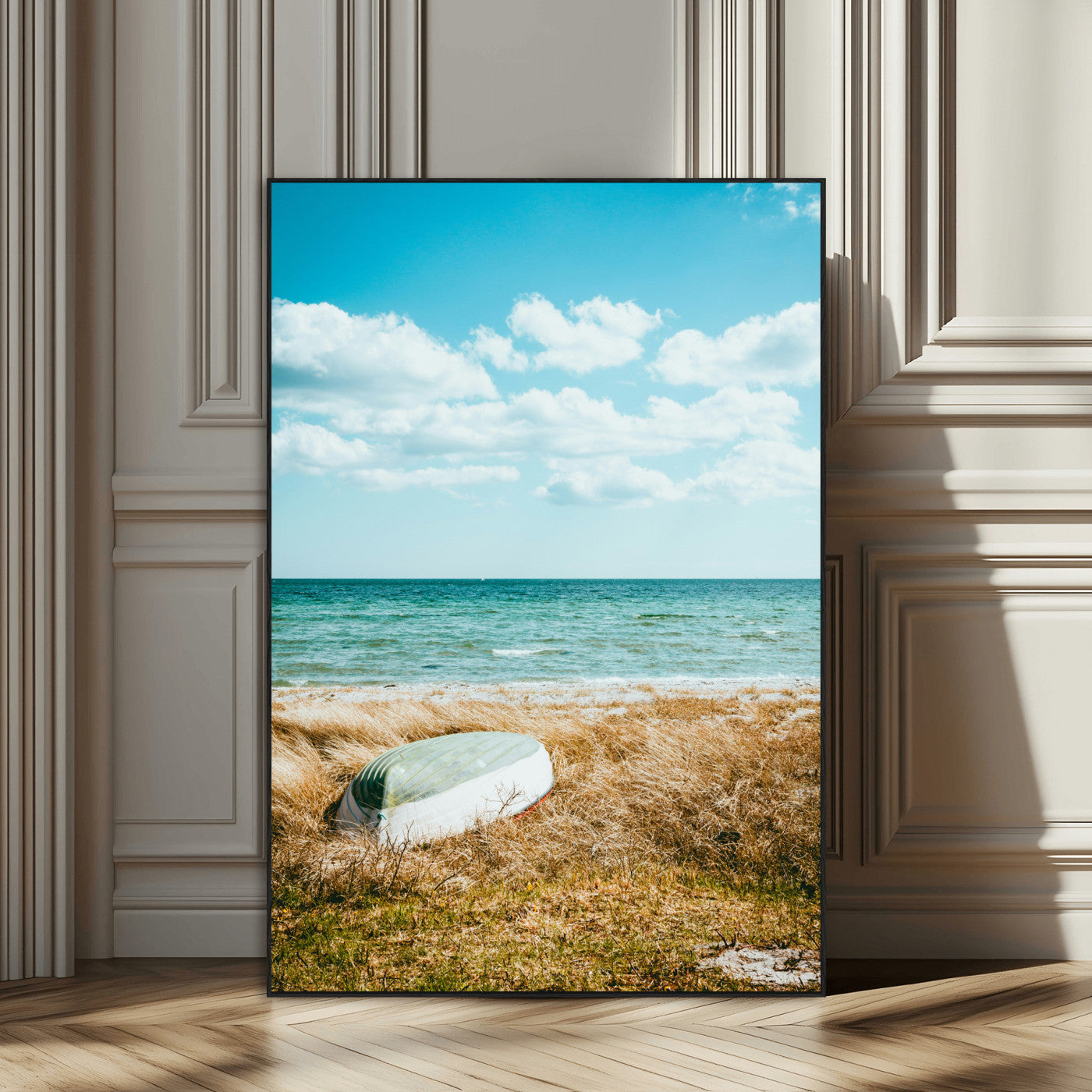 A small boat resting on a grassy shore with ocean waves and a bright blue sky, creating a peaceful coastal atmosphere.