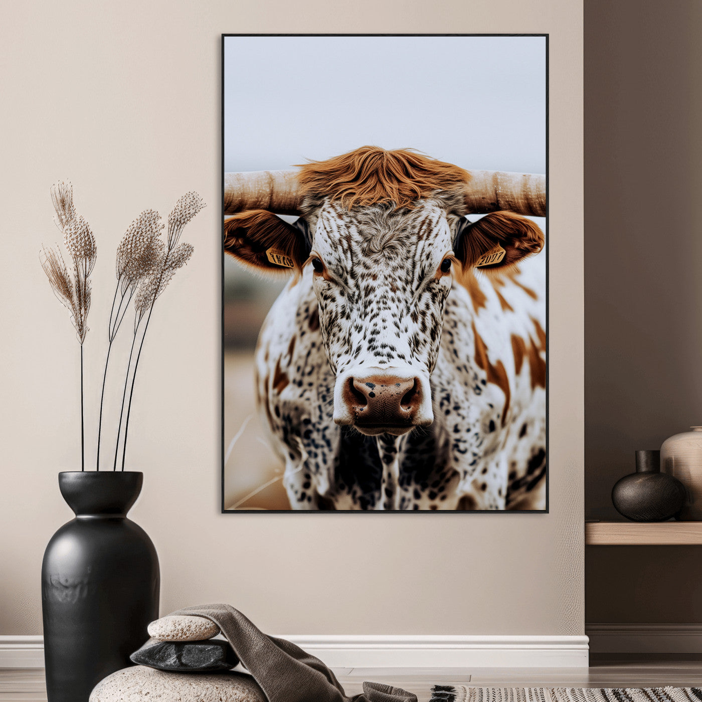 Close-up of a speckled Texas longhorn with wide horns and a bold gaze, perfect for rustic or country-style decor in warm tones.