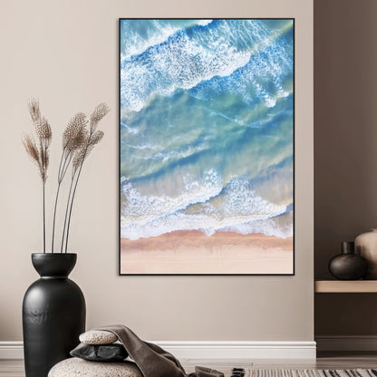 Aerial photo of soft blue waves meeting sandy shore, perfect for modern coastal or beach-themed decor with a light and tranquil aesthetic.