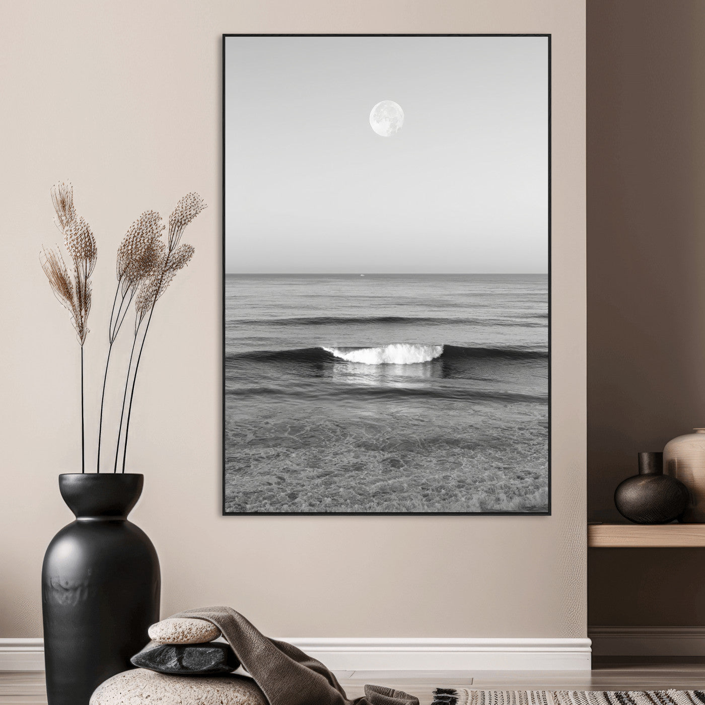 Black and white wall art of a calm ocean wave beneath a full moon, ideal for minimalist or monochrome coastal decor.