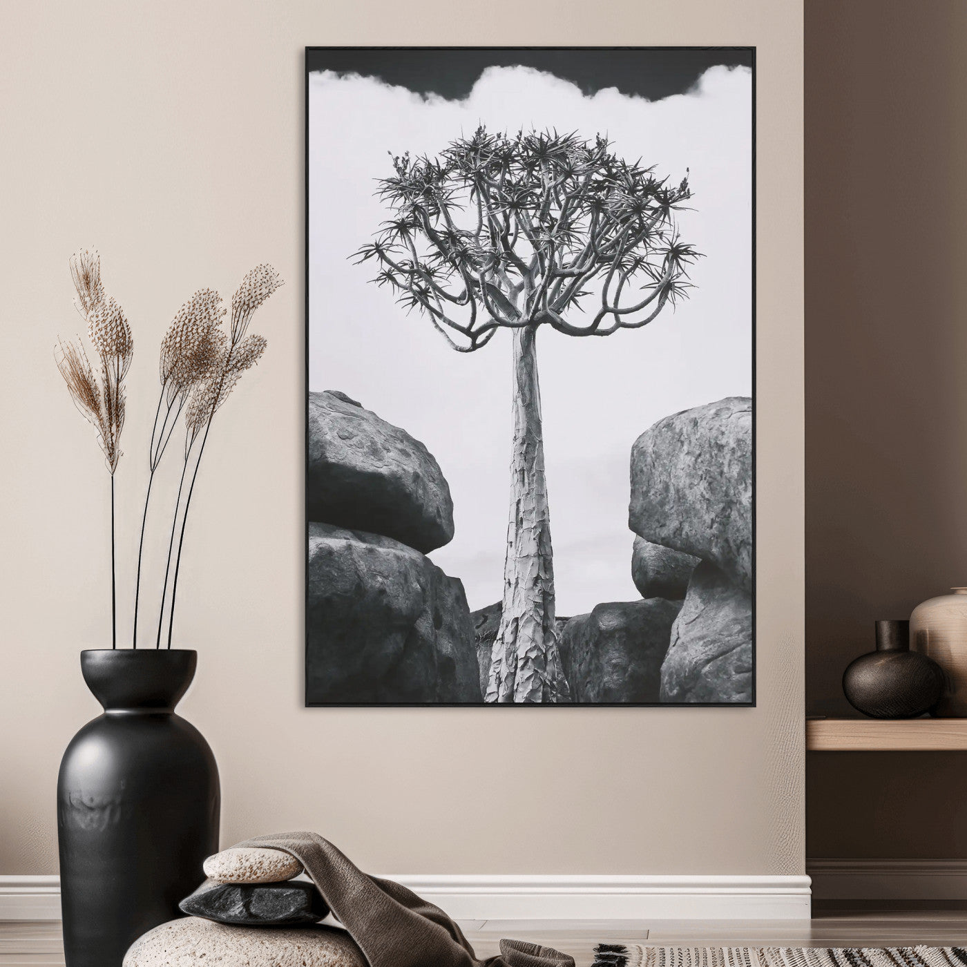 Tall desert tree in black and white, standing between large rocks, perfect for bold and minimalist nature-themed interior spaces.