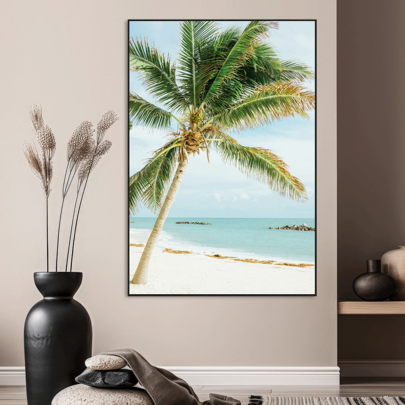 A tall palm tree leaning over a white sandy beach with turquoise ocean waves, creating a peaceful and tropical coastal scene.