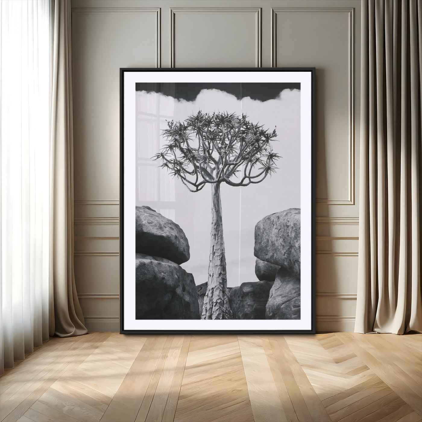 Tall desert tree in black and white, standing between large rocks, perfect for bold and minimalist nature-themed interior spaces.