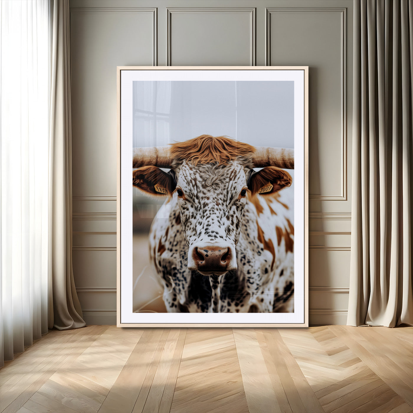 Close-up of a speckled Texas longhorn with wide horns and a bold gaze, perfect for rustic or country-style decor in warm tones.