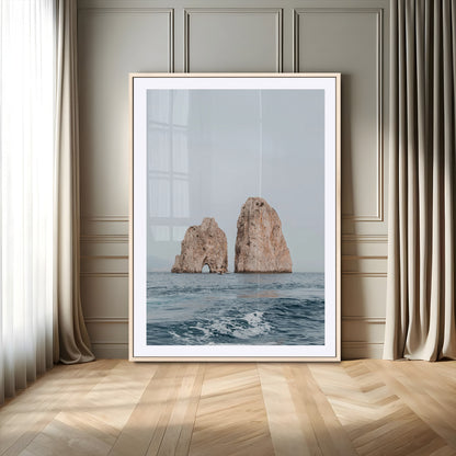 Serene photograph of the Faraglioni rocks in Capri with calm blue waters, perfect for Mediterranean coastal or minimalist travel-themed decor.