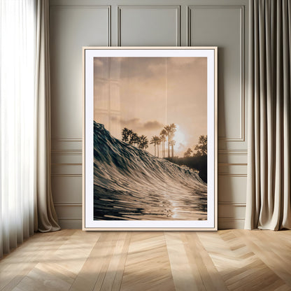 Golden sunset view of an ocean wave curling near palm trees, radiating warm tones perfect for coastal or tropical-themed decor.