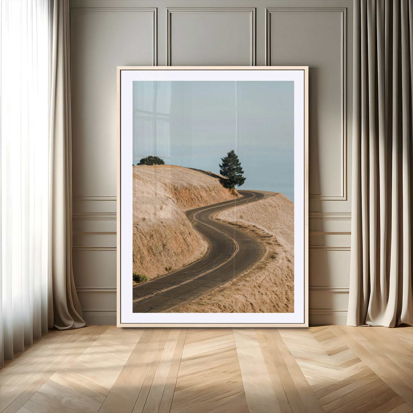 Earth-toned photograph of a winding road through golden hills, ideal for neutral or rustic-themed decor with a calming travel vibe.