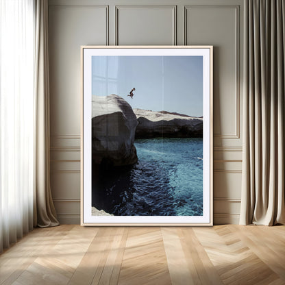Canvas of a cliff diver above turquoise waters and rocky coastline under clear sky, ideal for adventurous minimalist or coastal home decor.