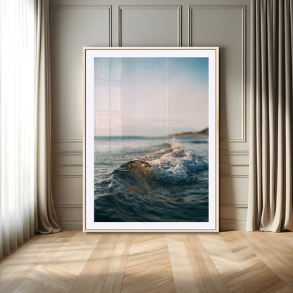 Close-up of ocean waves rolling gently toward the shore at sunset, creating a peaceful and minimalist coastal scene.
