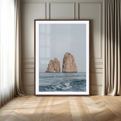 Serene photograph of the Faraglioni rocks in Capri with calm blue waters, perfect for Mediterranean coastal or minimalist travel-themed decor.