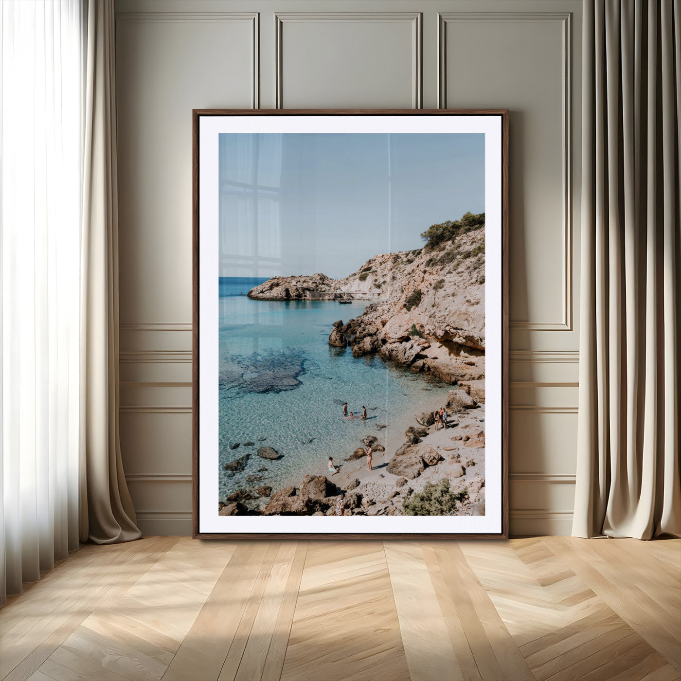 A vibrant coastal photo of a rocky Mediterranean cove with turquoise waters and beachgoers, ideal for boho coastal or summer-inspired interiors.