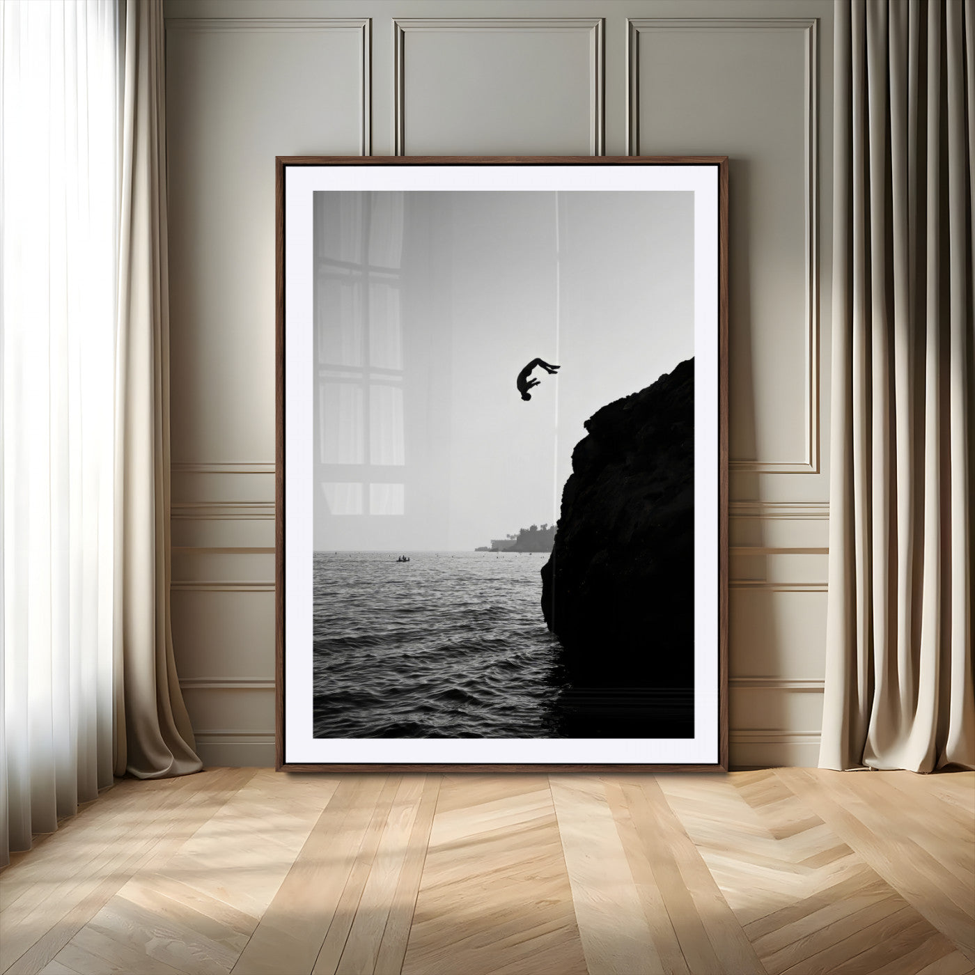 Silhouette of a person mid-air during a cliff jump over the ocean, captured in black and white for minimalist adventure decor.