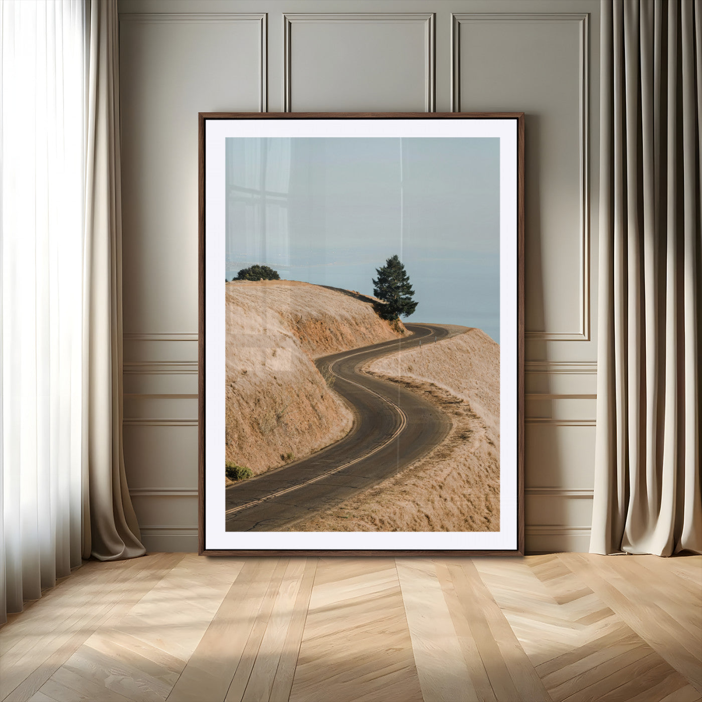Earth-toned photograph of a winding road through golden hills, ideal for neutral or rustic-themed decor with a calming travel vibe.
