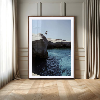 Canvas of a cliff diver above turquoise waters and rocky coastline under clear sky, ideal for adventurous minimalist or coastal home decor.