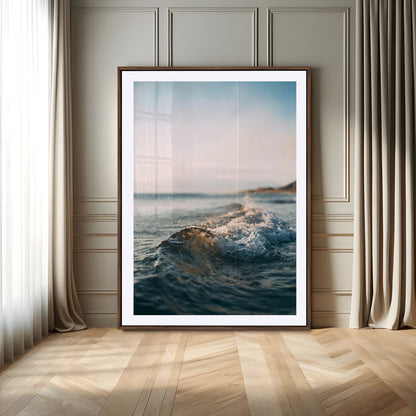 Close-up of ocean waves rolling gently toward the shore at sunset, creating a peaceful and minimalist coastal scene.