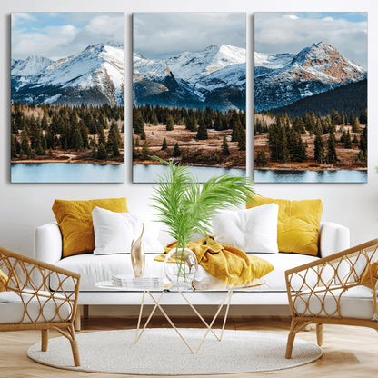 Framed canvas of snowy mountain peaks with pine forest and alpine lake, perfect for winter cabin or wilderness-inspired home decor.