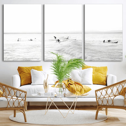 Monochrome photo of surfers riding and waiting on ocean waves, ideal for surf-themed or coastal energy wall decor.