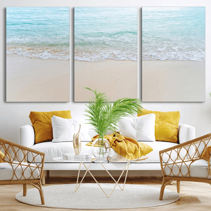 Soft shoreline with gentle aqua waves on smooth sand, ideal for minimalist coastal or pastel ocean-inspired home wall decor.