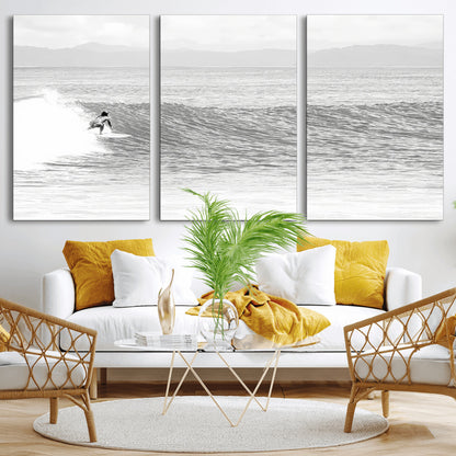 Monochrome photo of a surfer riding a wave with distant mountains, ideal for coastal motion or black and white surf-themed wall decor.