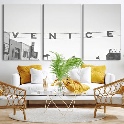 Black and white photo of Venice Beach sign and palm-lined street, perfect for urban coastal or minimalist LA-inspired wall decoration.