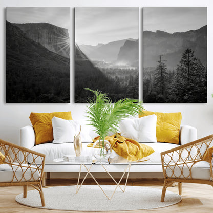 Black and white landscape of Yosemite with sun rays peeking over El Capitan, ideal for moody nature or modern rustic decor.