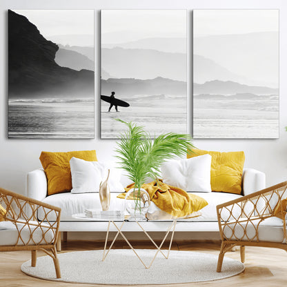 A lone surfer walking along a misty beach with cliffs in the background, carrying their board, capturing a serene and minimal ocean moment.