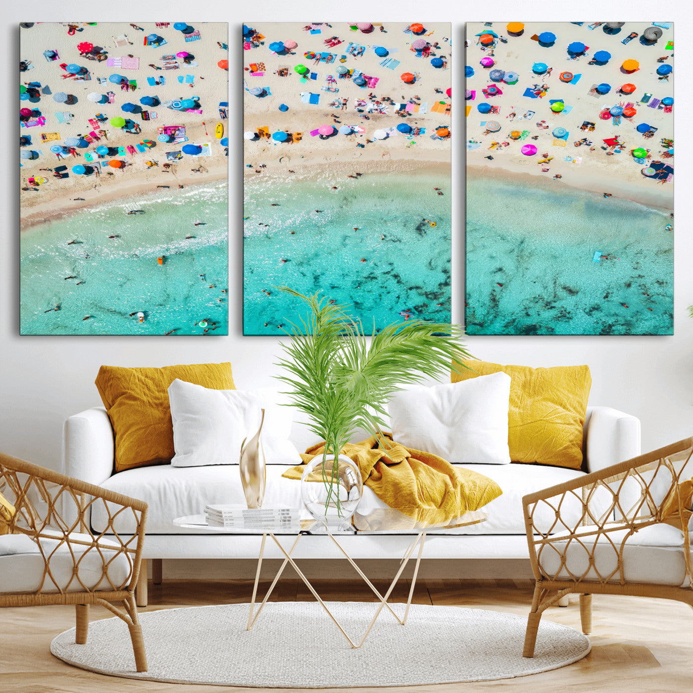 Aerial view of a vibrant beach filled with colorful umbrellas and people enjoying the turquoise ocean, capturing a lively summer vacation scene.