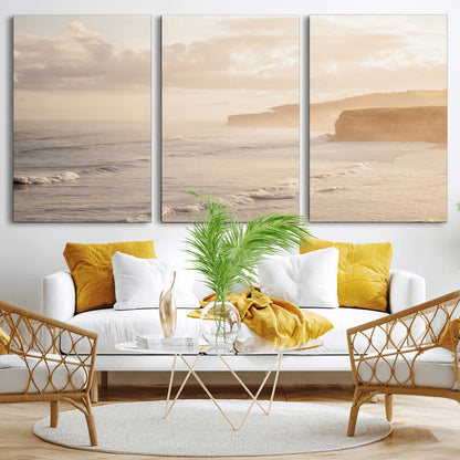 Golden hour seascape with misty cliffs and gentle waves rolling towards the shore, capturing a tranquil and warm coastal atmosphere.