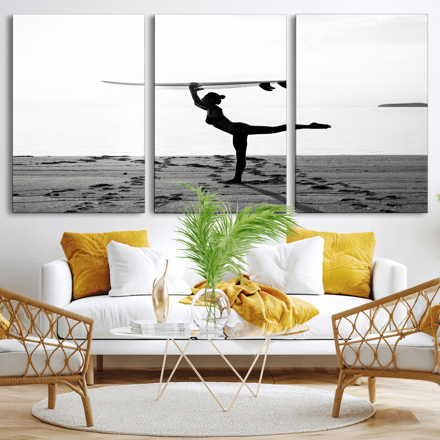 A woman balances a surfboard on her head while striking a yoga pose on the beach, silhouetted against a calm ocean horizon.