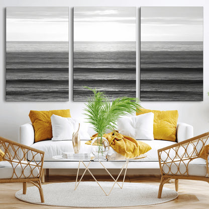 Minimalist black and white ocean view with layered waves reflecting sunlight, evoking a sense of calm and coastal serenity.