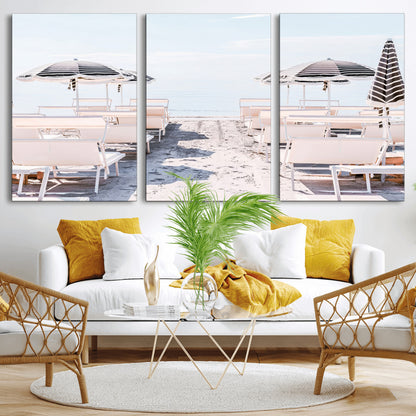 A serene minimalist beach scene featuring striped umbrellas, soft pastel sand, and an elegant lounge setup, creating a tranquil and stylish coastal retreat.