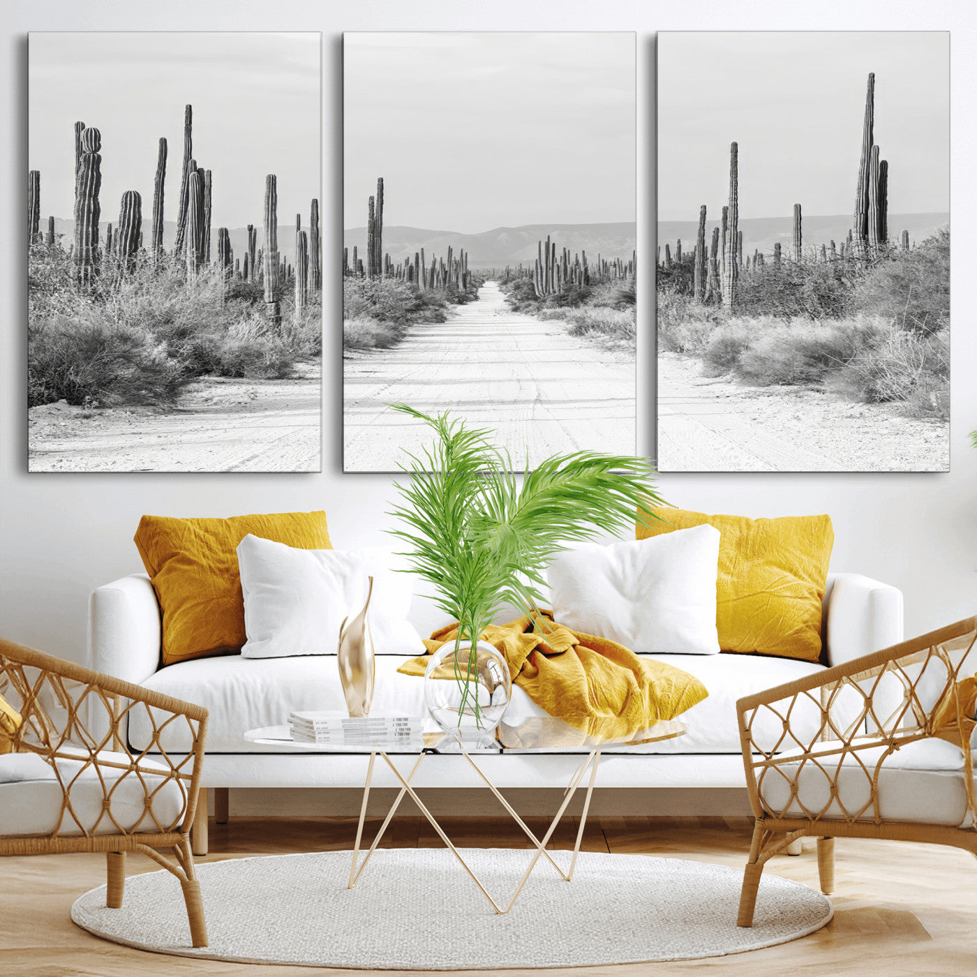 A black and white desert road stretching through a cactus-filled landscape, creating a rugged and timeless southwestern aesthetic with a sense of adventure.