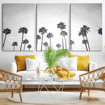 A black and white minimalist scene featuring tall palm trees silhouetted against a bright sky, creating a dreamy and timeless tropical aesthetic.