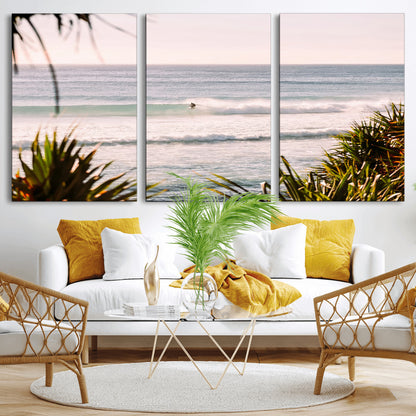 Canvas of a lone surfer riding a pastel wave at sunrise, perfect for tropical or coastal-themed spaces with a relaxed, airy vibe.