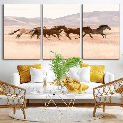A herd of wild horses galloping through a sunlit desert plain with mountains in the background, perfect for rustic or western-themed wall decor.
