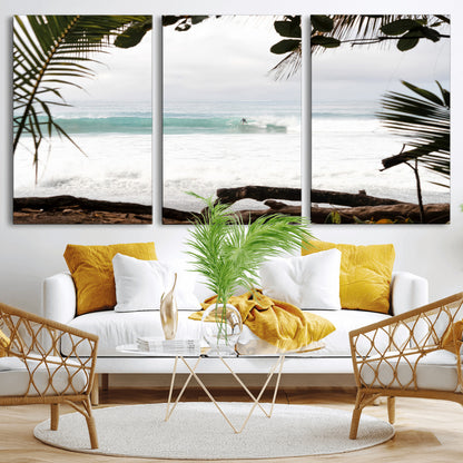 Tropical beach view with palm trees and surfer riding a wave, perfect for boho or coastal-inspired interior wall decor.