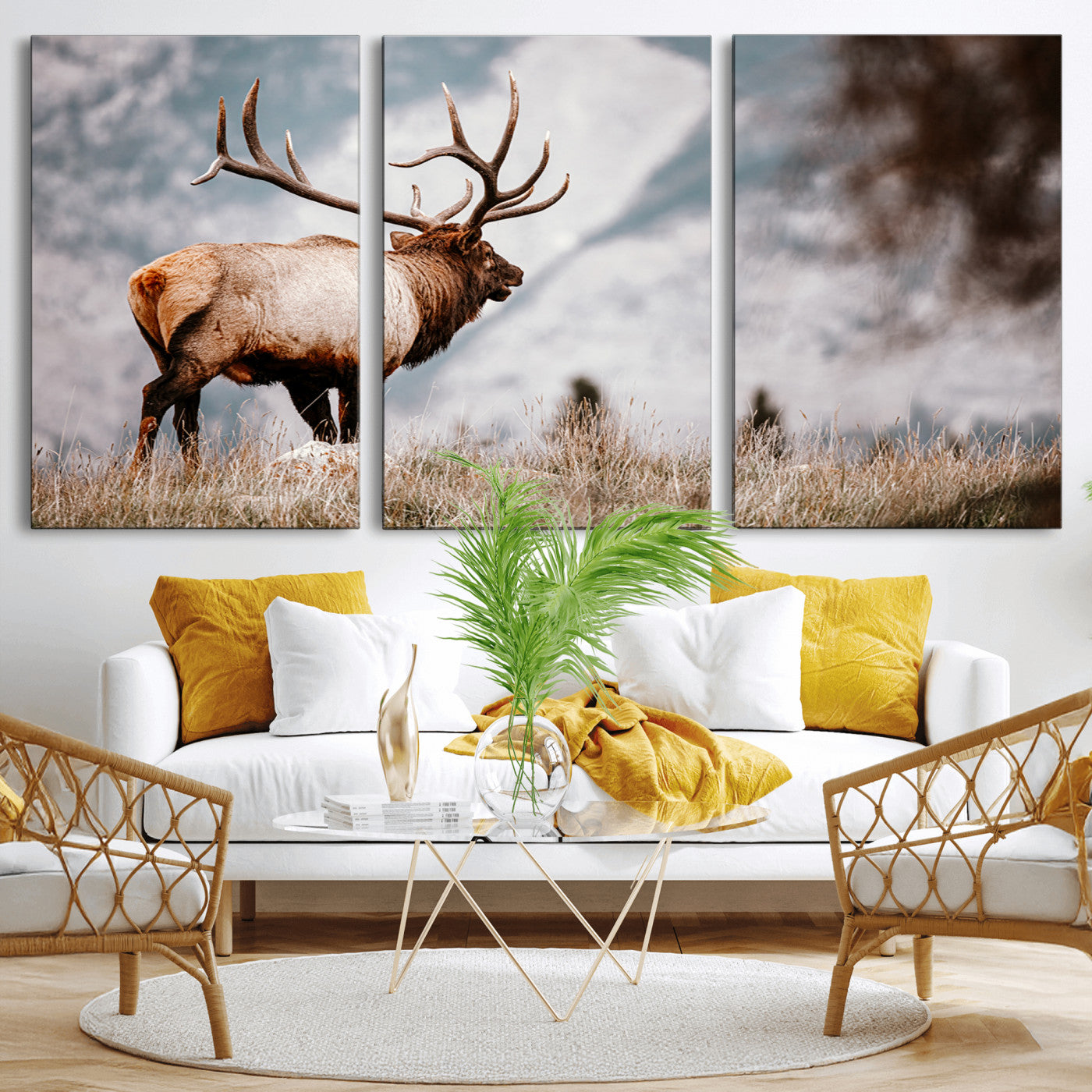 Majestic elk with large antlers standing in grass with snowy mountains in background, perfect for rustic cabin or lodge style decor.